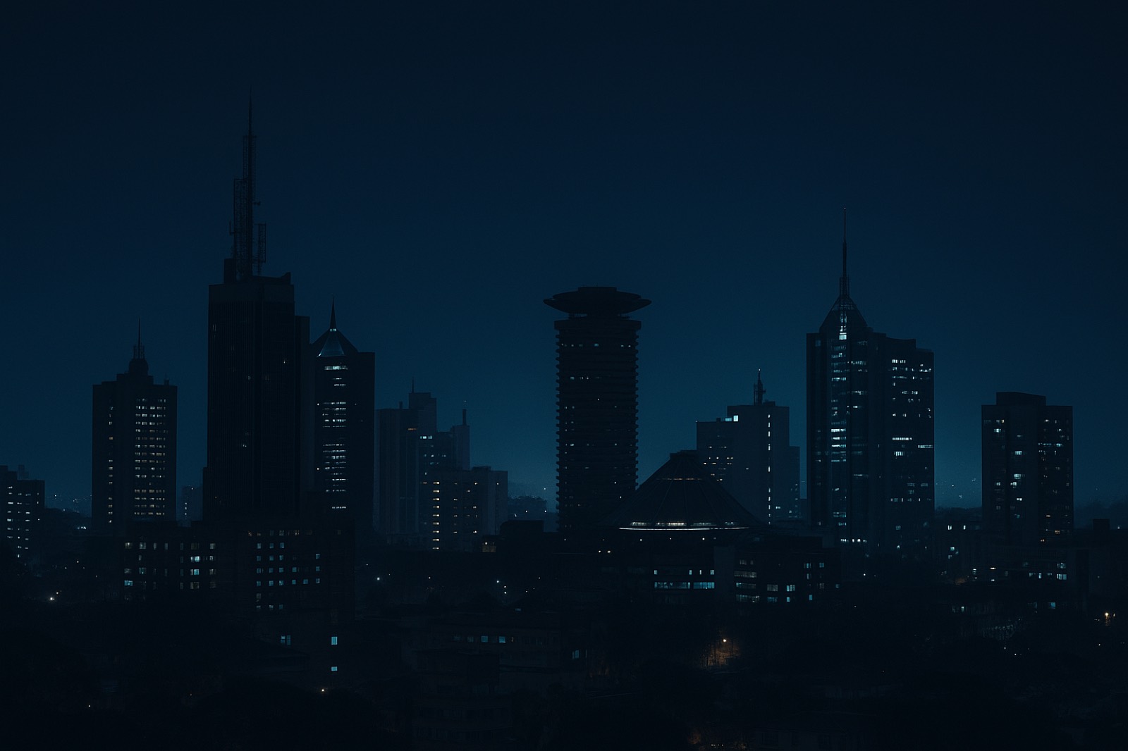 The Nairobi skyline at night under a deep navy sky